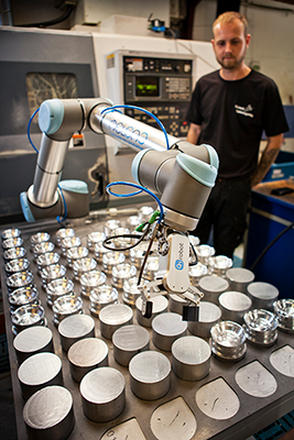 Robot grippers designed for human-robot collaborative operation load and unload metal parts in a CNC machine tending application. (Courtesy of On Robot A/S)