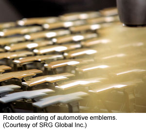 A robot applies paint to automotive emblems (Courtesy of SRG Global Inc.)