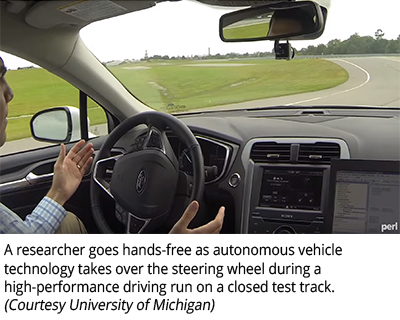 A researcher goes hands-free as autonomous vehicle technology takes over the steering wheel during a high-performance driving run on a closed test track. (Courtesy University of Michigan)