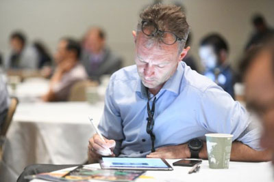 Man using tablet at RoboBusiness