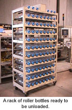 A rack of roller bottles ready to be unloaded.